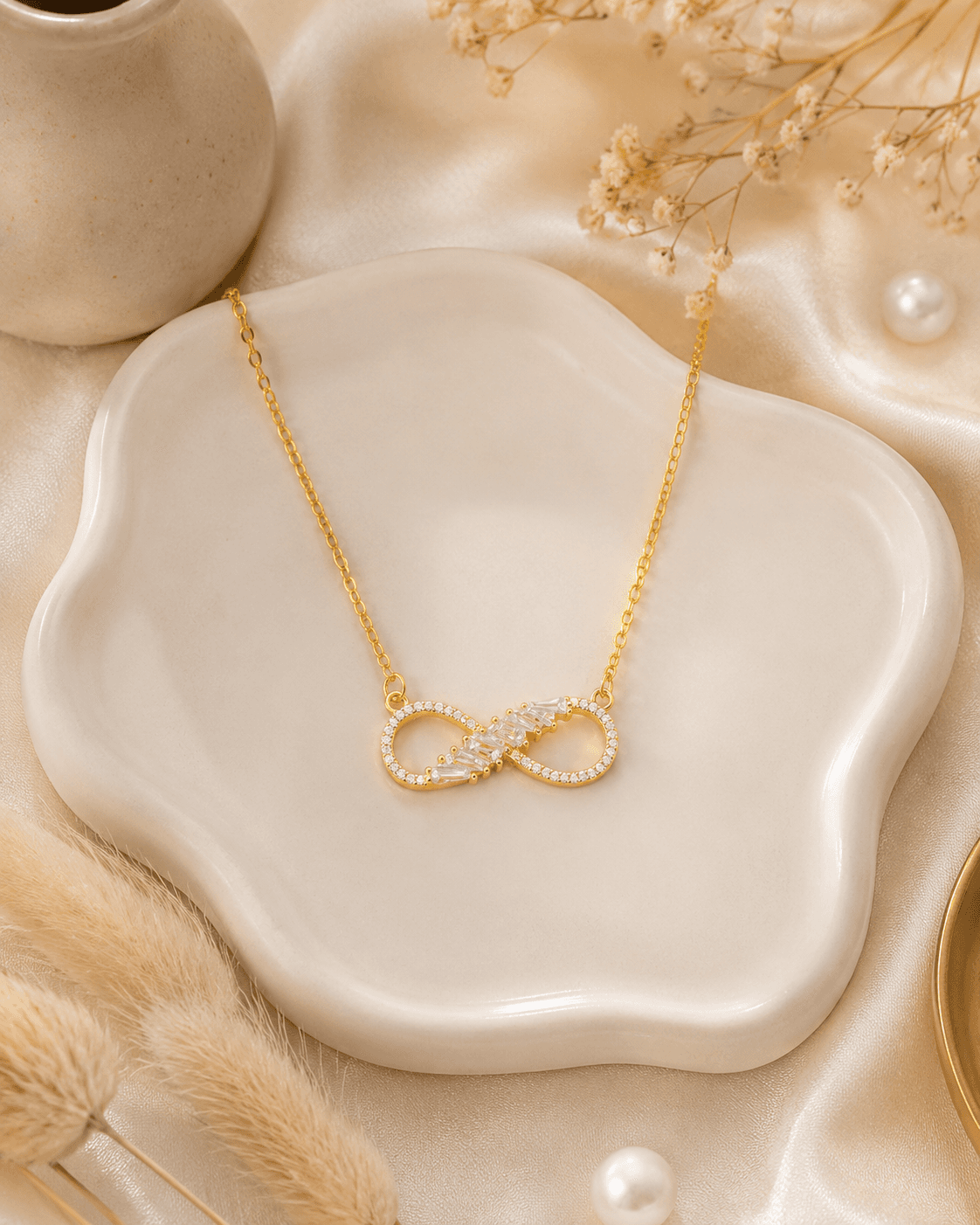 Delicate gold-tone chain necklace with polished infinity centrepiece