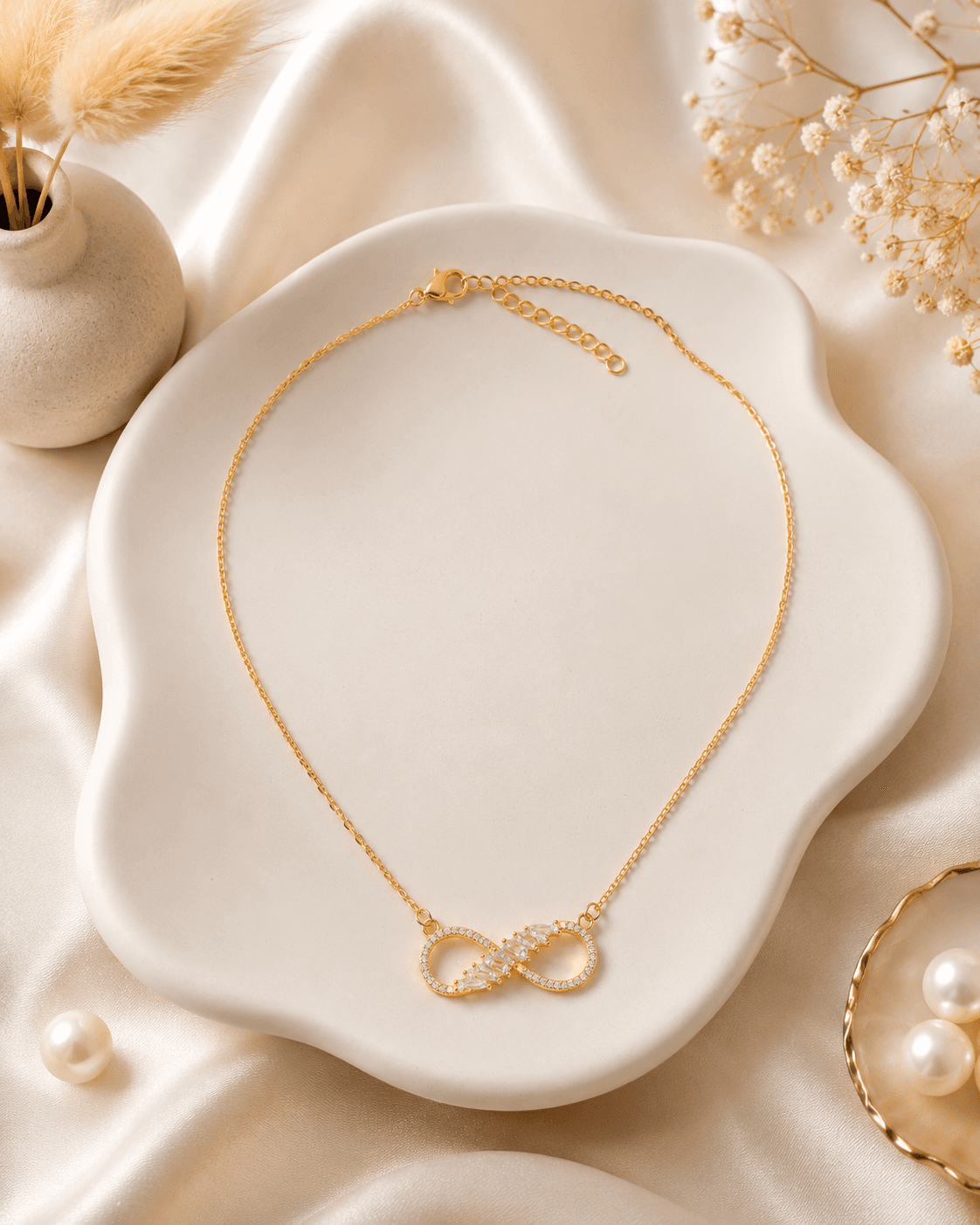 Delicate gold-tone chain necklace with polished infinity centrepiece