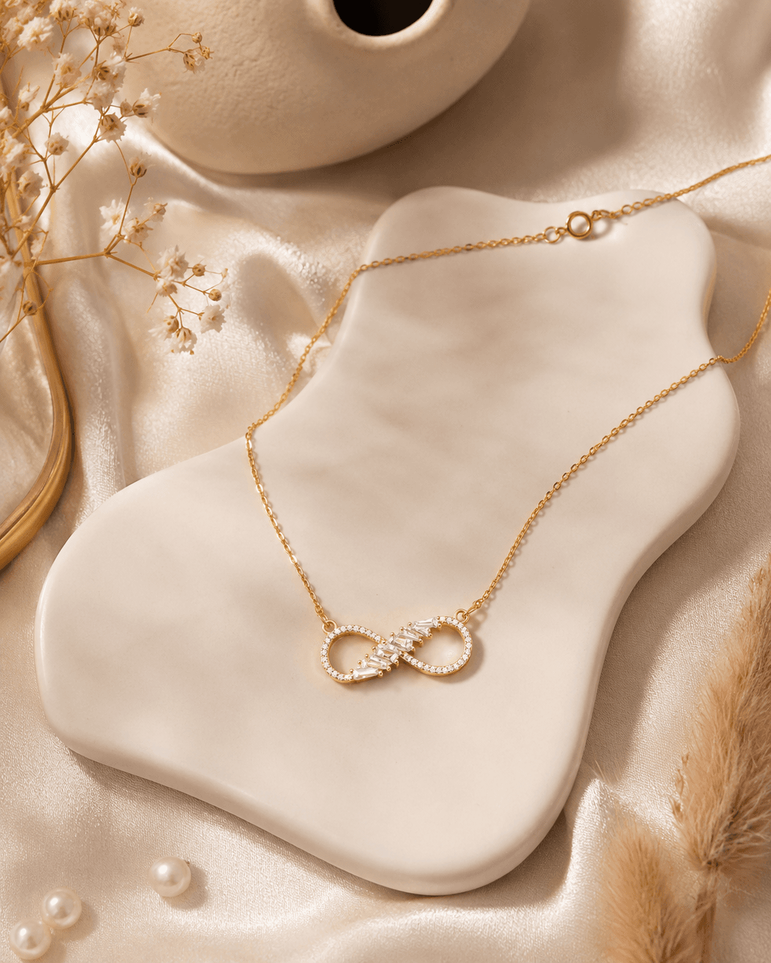Delicate gold-tone chain necklace with polished infinity centrepiece